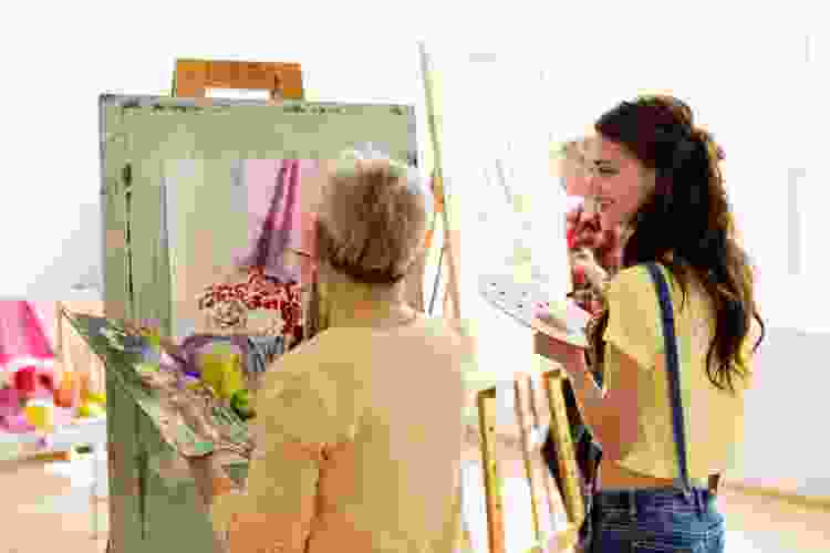 two women painting side by side