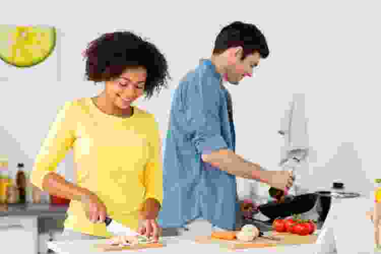 couple cooking dinner together at home