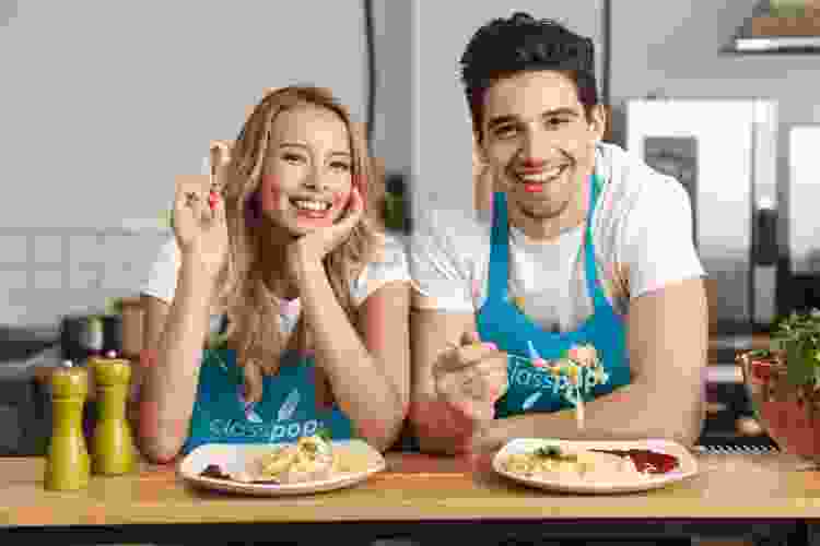 couple posing with spaghetti after cooking class