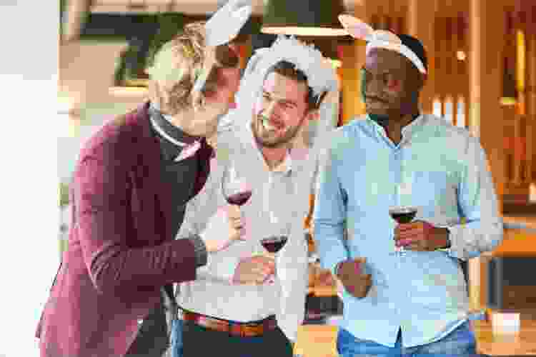 group of men drinking wine in costumes