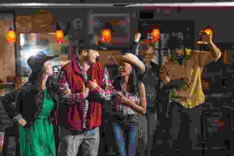 group of country line dancers at bar