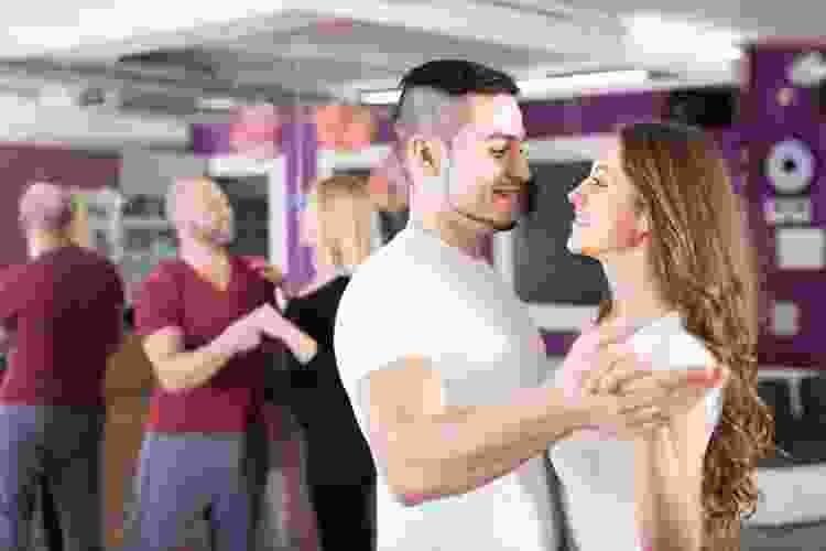 couples learning to dance in dance studio