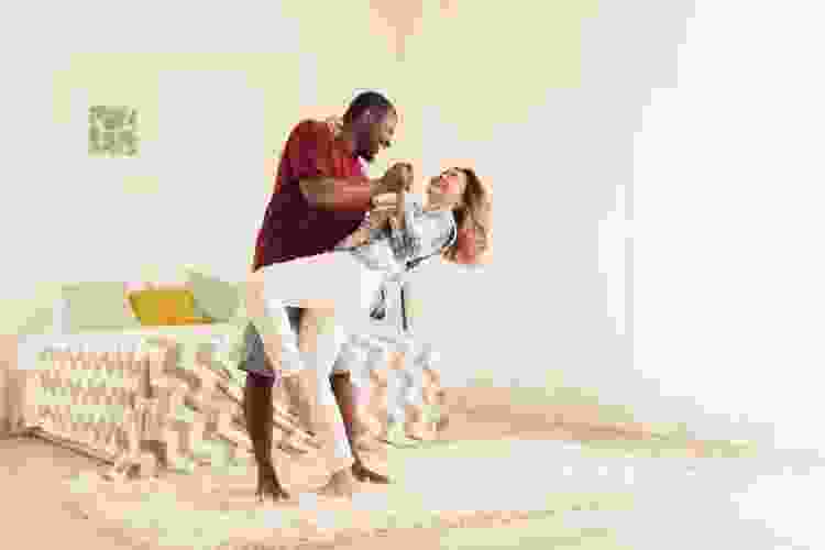 couple dancing in the bedroom at home