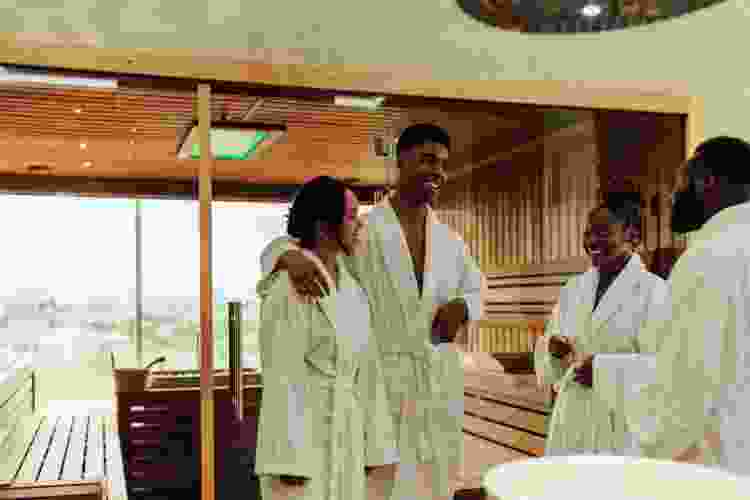 two couples in robes chatting at the day spa