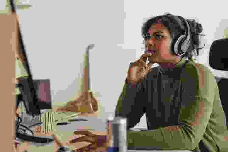 woman using headphones at desk