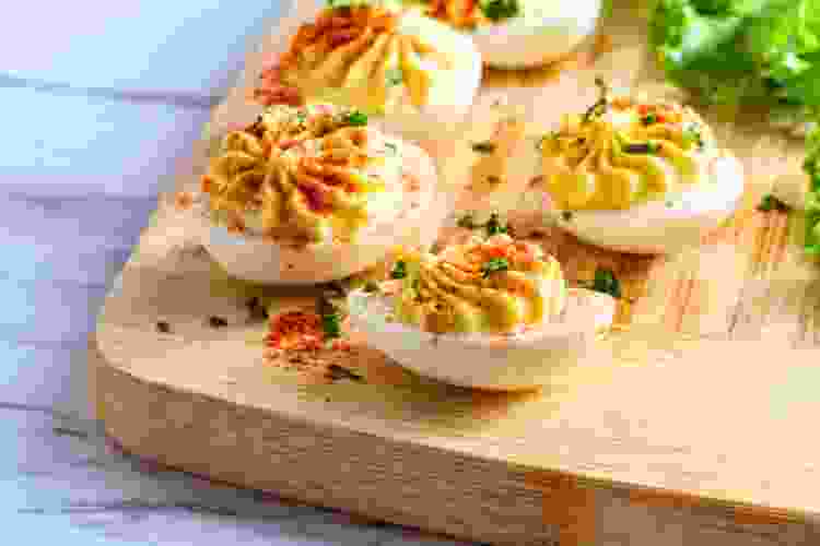 deviled eggs on cutting board