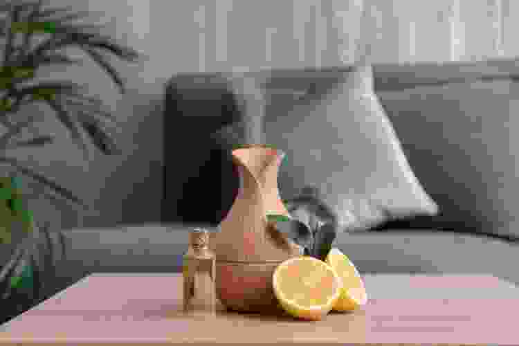 essential oil diffuser next to sliced lemons