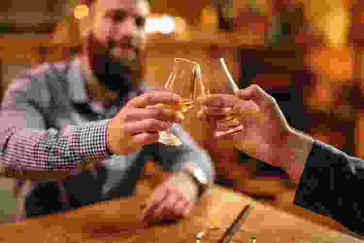 couple tasting bourbon at distillery