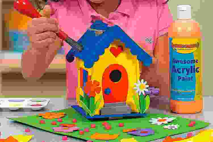 kid painting wooden birdhouse craft