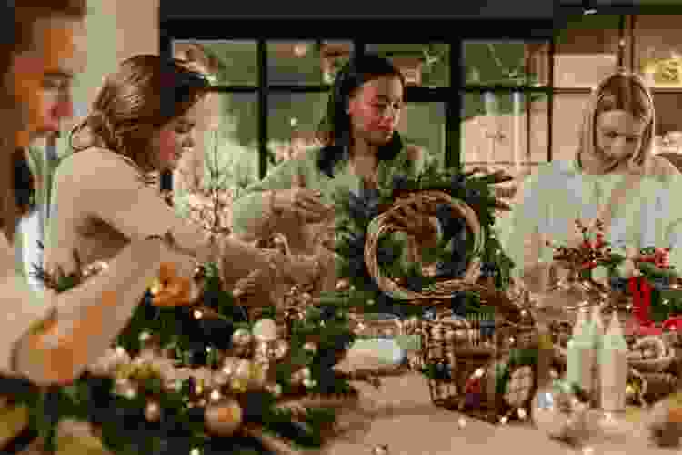 group of women making holiday wreaths