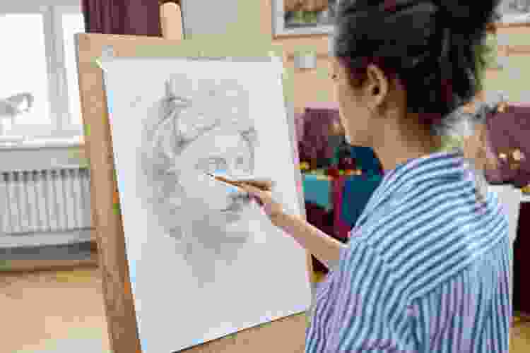 woman drawing portrait in drawing class