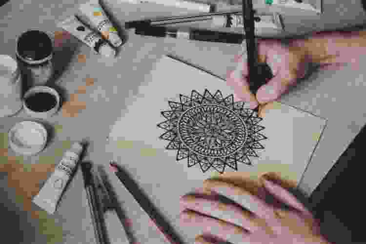 hand sketching a black and white mandala