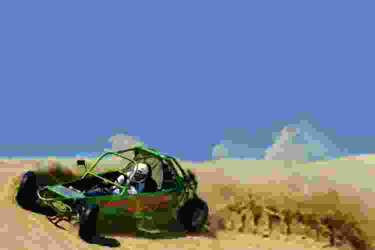 kicking up sand in dune buggy