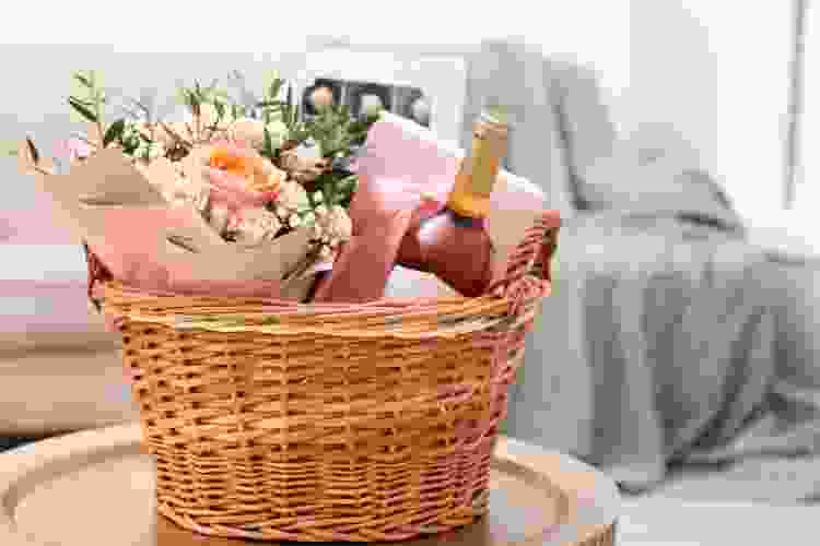 spring gift basket with pink wine and flowers