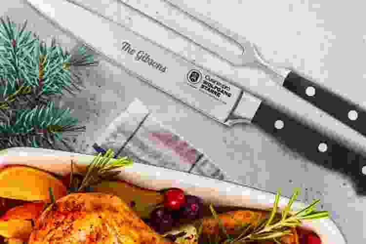 engraved chef knives next to roast turkey