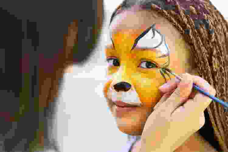 young girl with orange butterfly face paint