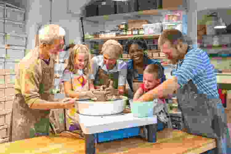 family doing pottery together in studio