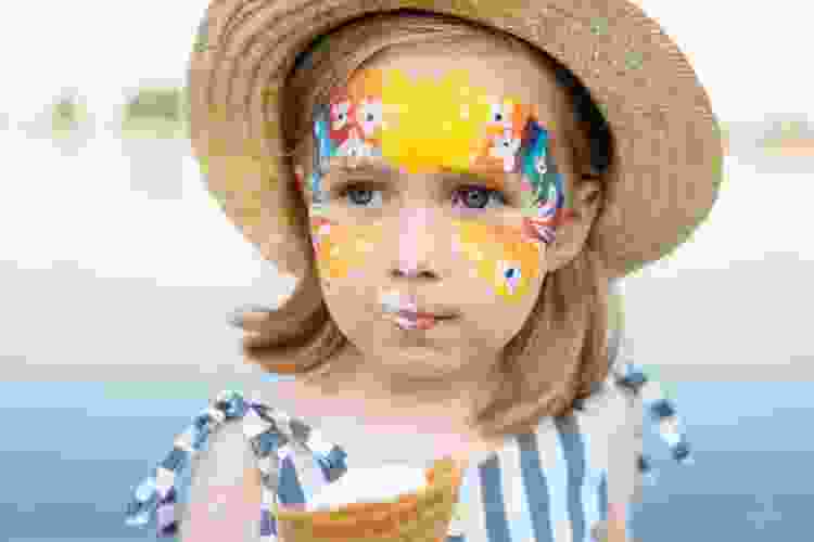 young girl with flowers painted on her face