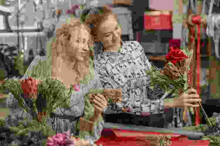 women arranging flowers together