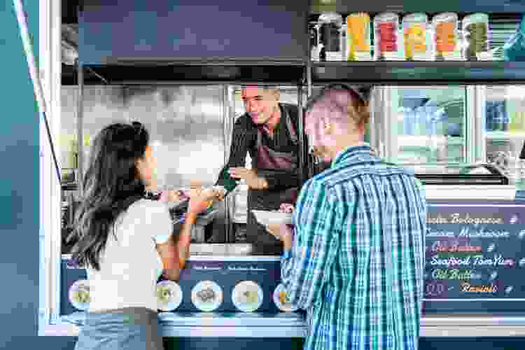 couple ordering street food at market