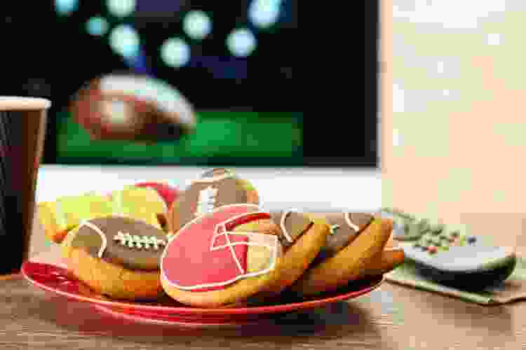 cookies decorated like footballs and jerseys