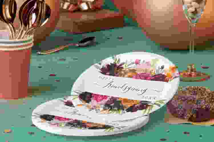 custom Friendsgiving decorations and paper plates on table