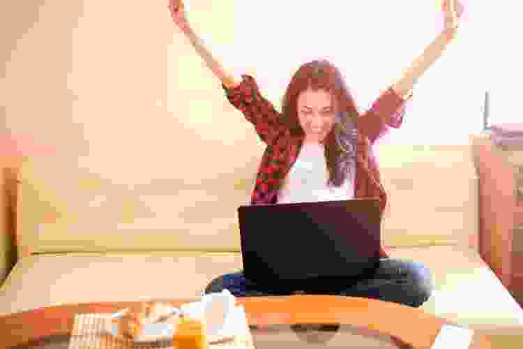 woman celebrating win on computer game