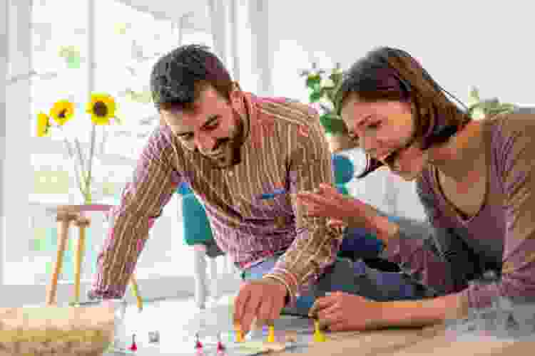 couple playing vintage board game on the floor