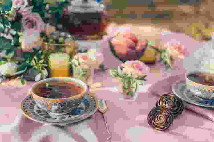 pretty pink table in the garden with flowers and tea set