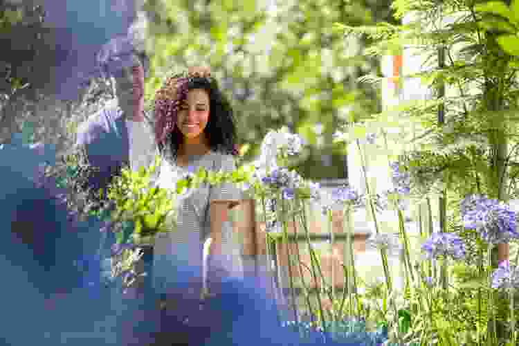 couple in garden surrounded by flowers