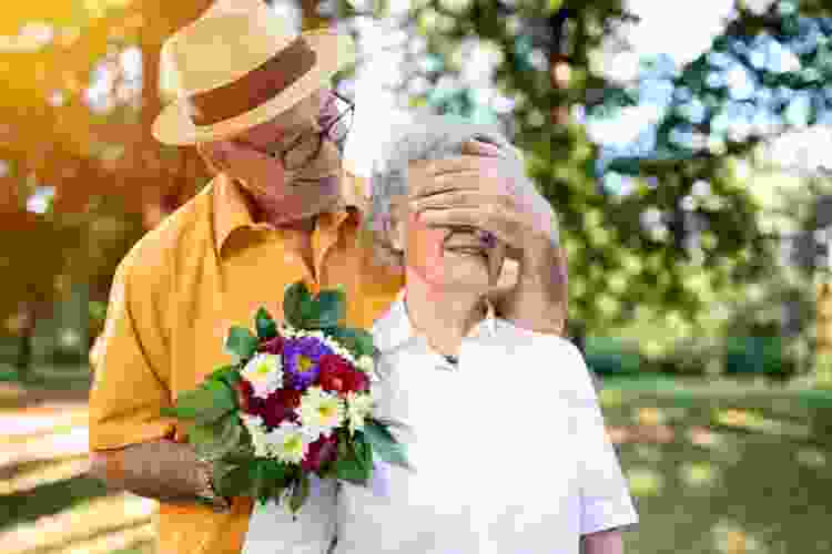 husband giving surprise flowers