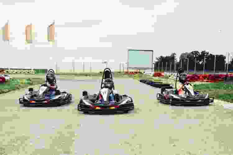 group of teens racing in go karts