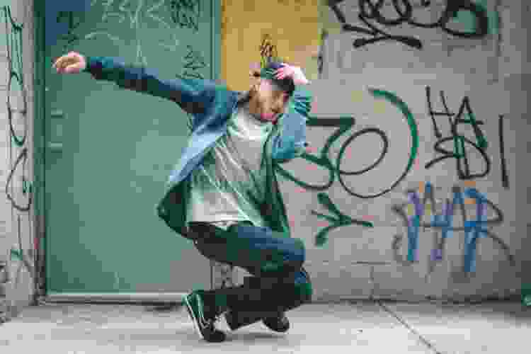 graffiti behind hip hop street dancer