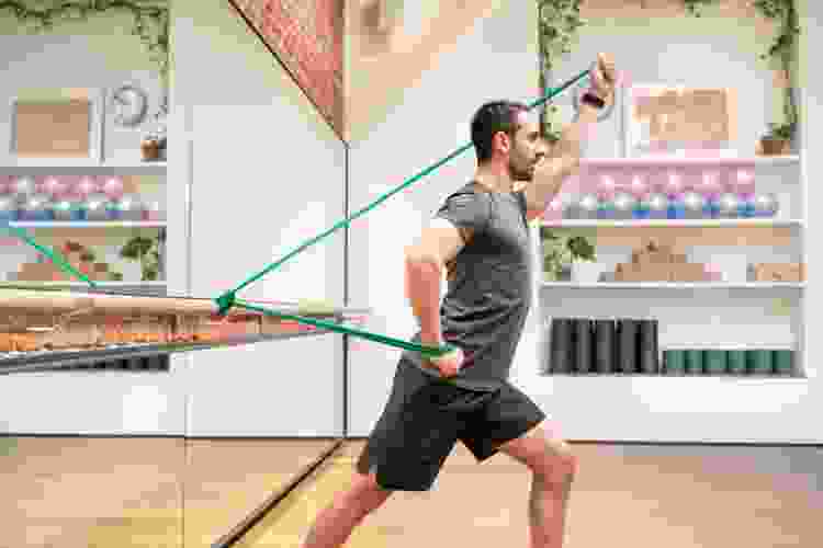 man exercising with resistance bands