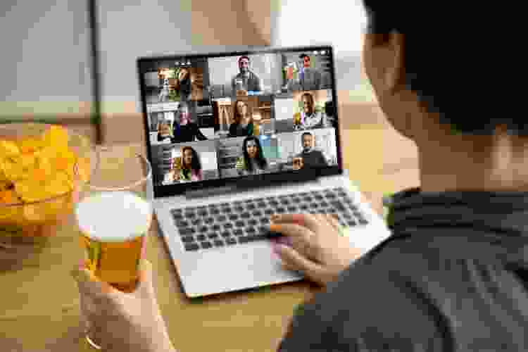 person drinking a beer at home on a video call with other people drinking beer