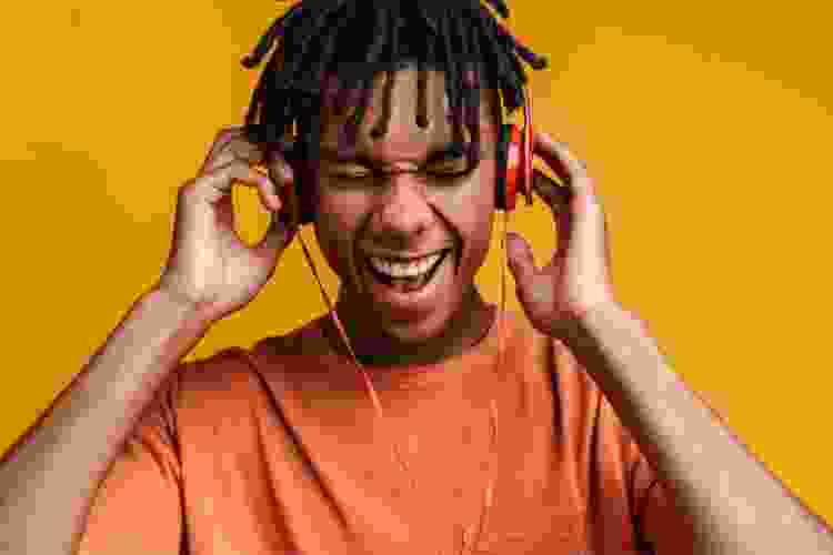 teen boy jamming out to music in headphones