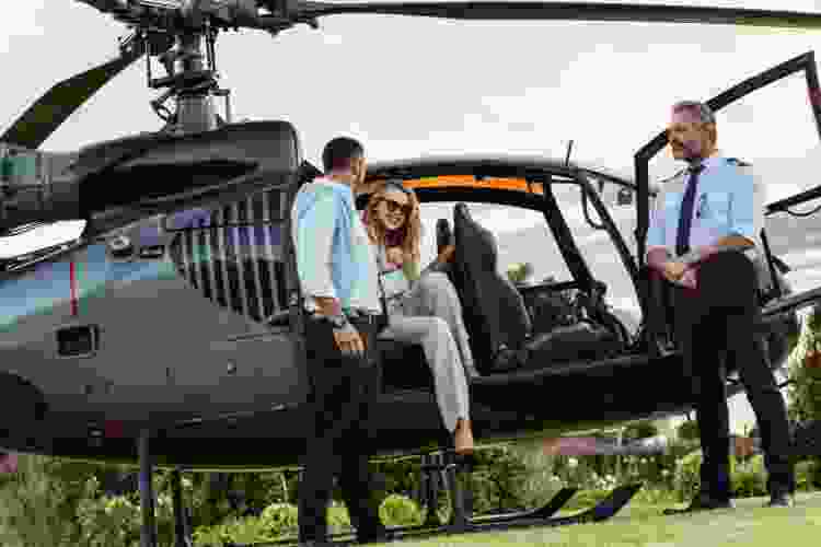 couple getting onto helicopter for a tour