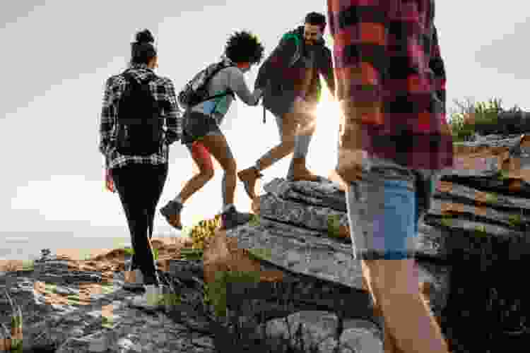 group of friends hiking on rocks