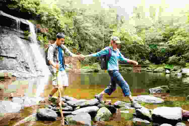 couple hiking near waterfalls