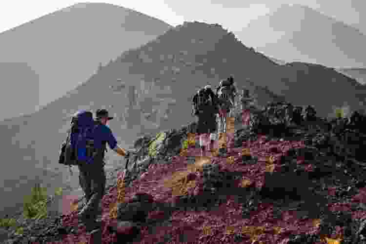 people hiking up a mountain