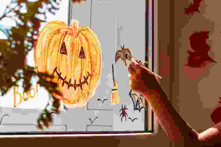 halloween pumpkin painting on window glass