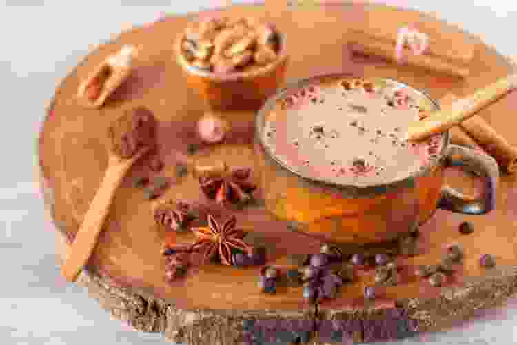 hot cocoa in mug on wooden plate