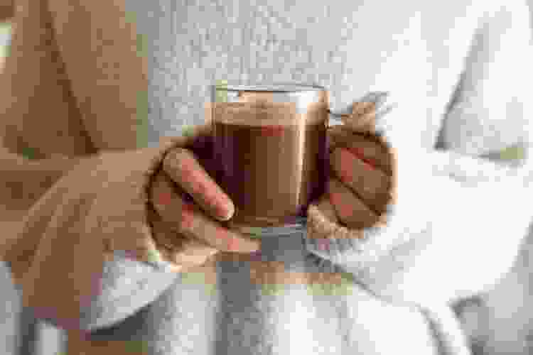 holding cup of hot chocolate 