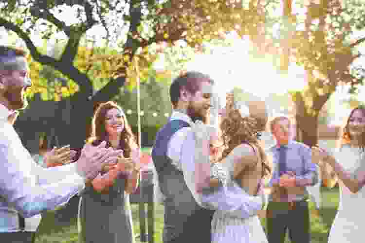 married couple slow dancing at their outdoor wedding reception