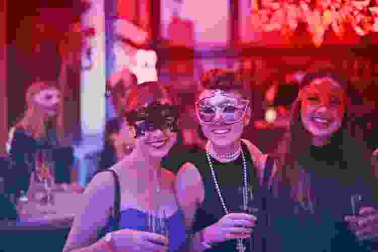 group of friends dressed up at a masquerade ball