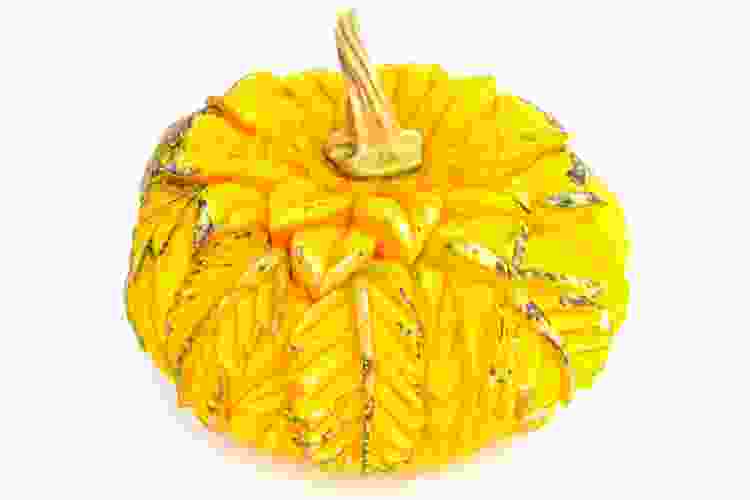 yellow pumpkin carved with intricate leaves