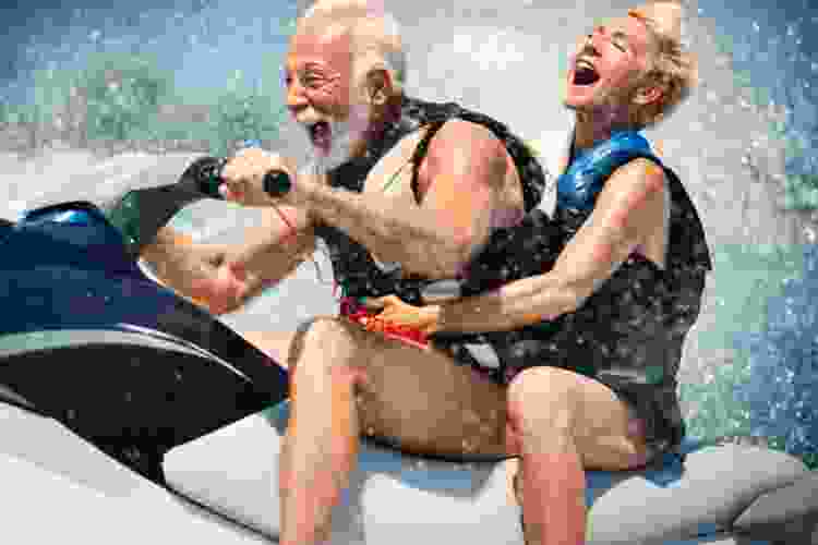 happy older couple jet skiing 