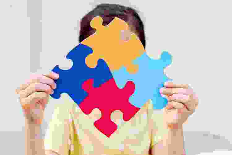 Child holding jigsaw puzzle