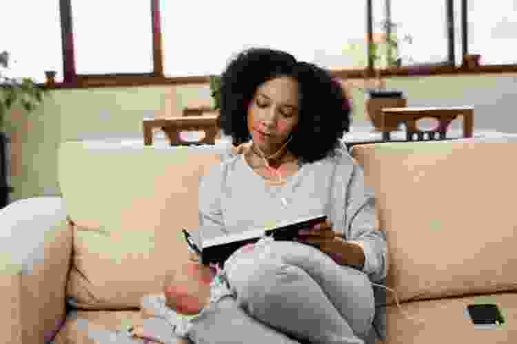 woman writing in journal listening to music