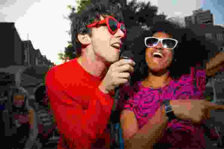 couple singing karaoke in sunglasses